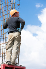 Man worker mounting concrete formwork during construction works