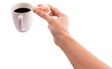 Female hand holding doughnuts with a mug of coffee