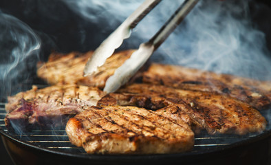 Grilled steaks on barbecue