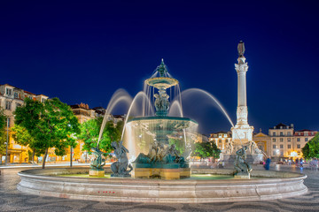 Romantic Lisbon street. Fountain at night in the center
