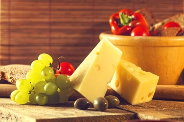 Close up of cheese piece with green grapes
