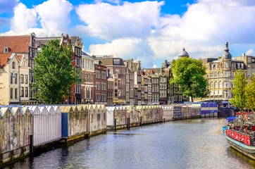 Deurstickers Scenic view of canal in Amsterdam at flower market © Martin M303