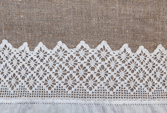 Burlap background with lacy and linen cloth