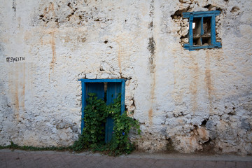 Traditional house in Crete with a sign 'for sale', Greece.