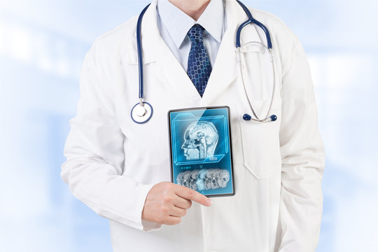 Doctor with MRI scan on tablet screen