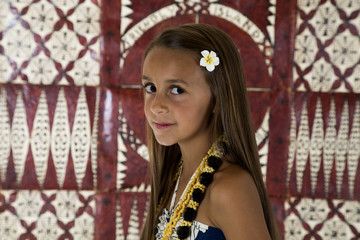 Young tan girl with tapa cloth background