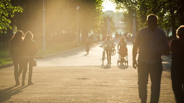 People of all ages walk in spanking at sunset