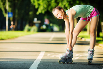 Rollerblading woman. Young woman skating in the park. 