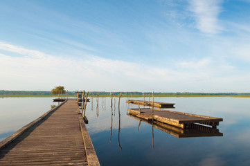 Wooden pier in a lake. Sunrise at Soustons, France