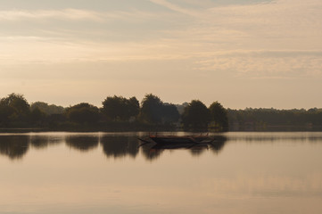 Fototapeta na wymiar Wooden boat in the lake shore
