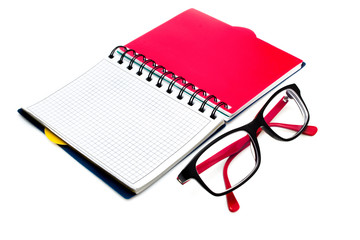 Glasses and notebook isolated on white