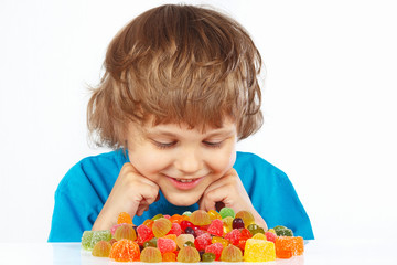 Child with jelly candies on a white background