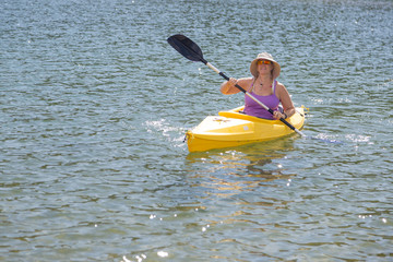 Woman Kayaking on Beautiful Mountain Lake.