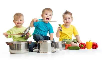 Kids group cooking isolated on white. Three boys are playing wit