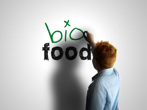 Bio food. Boy writing on a white board