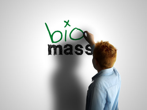 Bio mass. Boy writing on a white board