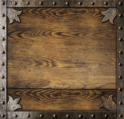 medieval metal frame over old wooden background