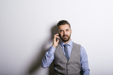 Hipster businessman with mobile phone