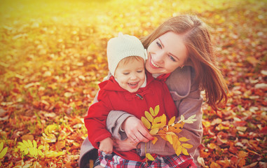 happy family: mother and child little daughter on autumn