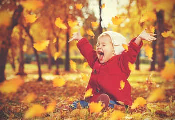 Poster happy little child, baby girl laughing and playing in autumn © JenkoAtaman