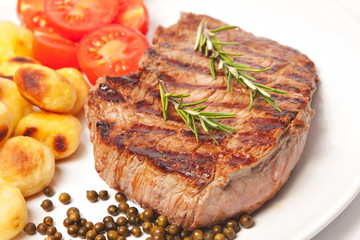Steak with potatoes and tomatoes