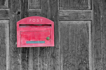 Red wooden mail box on wooden wall