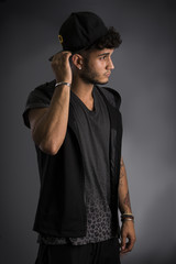 Fototapeta na wymiar Profile of handsome young man in dark t-shirt and baseball hat