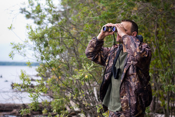 hunter looking through binoculars