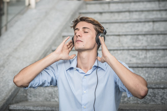 young model hansome blonde man with headphones