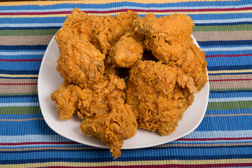 White Plate of Fried Chicken on Striped Placemat