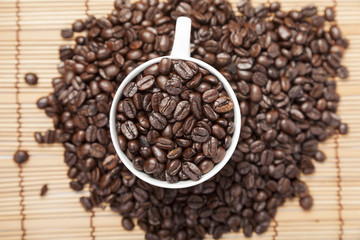 Coffee beans in coffee cup