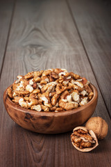 walnuts in the brown wooden bowl