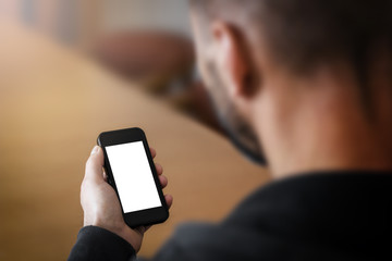 Man holding a smartphone with blank screen.