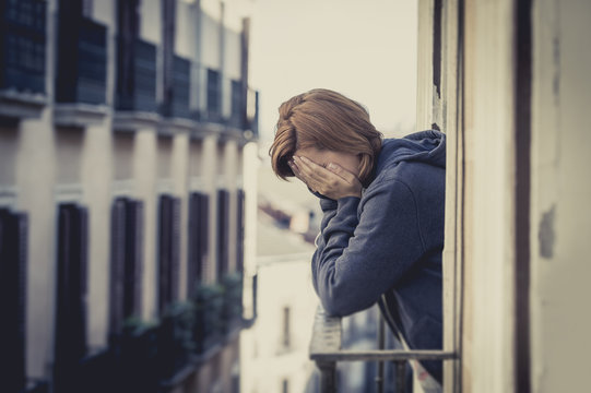 young woman suffering depression and stress at home balcony