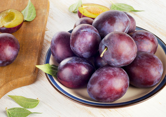 Plums on a  wooden table