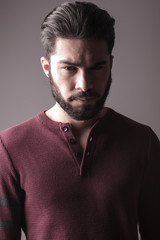 beard man in burgundy sweater, looking at the camera