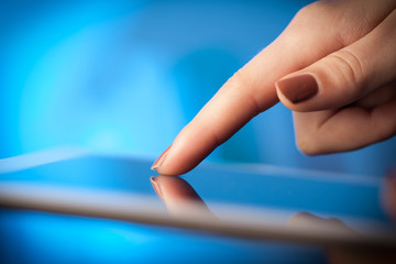 Finger pointing on tablet pc with empty space