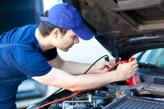 Professional car mechanic working in auto repair service.