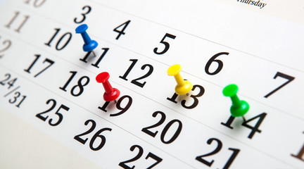 large wall calendar with needles