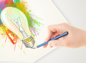 Hand drawing on paper a colorful splatter lightbulb