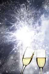 Glasses with champagne against fireworks