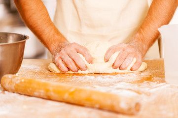 Man kneading the dough.