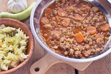 Meat sauce with vegetables cooked in pan with pasta
