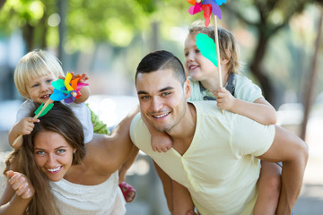 Obraz premium family of four walking with children on vacation