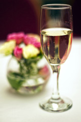 Bouquet of roses and glass of champagne