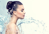 Beautiful model woman with splashes of water in her hands