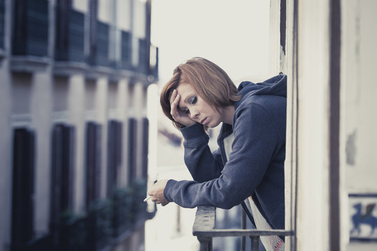 young woman suffering depression and stress outdoors at  balcony