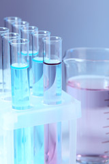 Test tubes with liquid on grey background