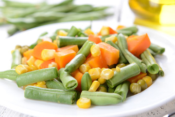 Delicious vegetables salad on plate on table close-up