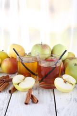 still life with apple cider and fresh apples on wooden table